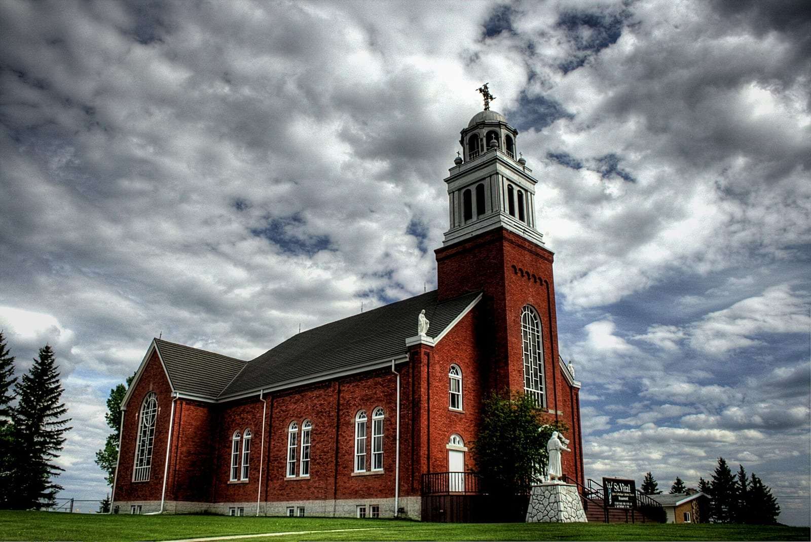 Saint Vital Roman Catholic Church, a red brick church, in Beaumont, Alberta